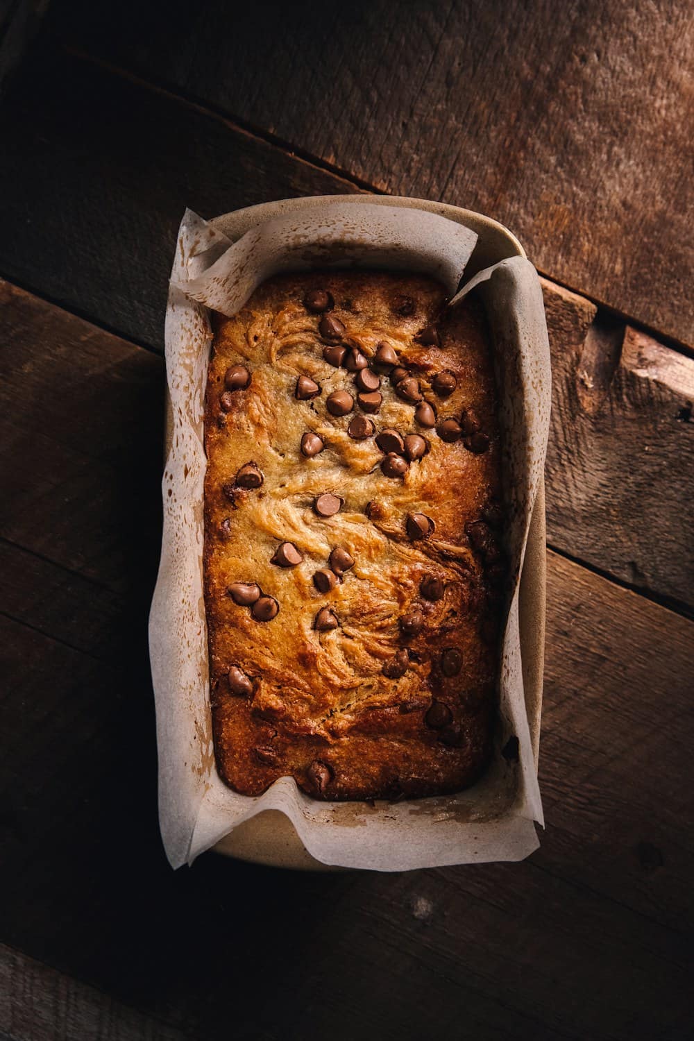 A banana loaf in its baking paper, seen from above