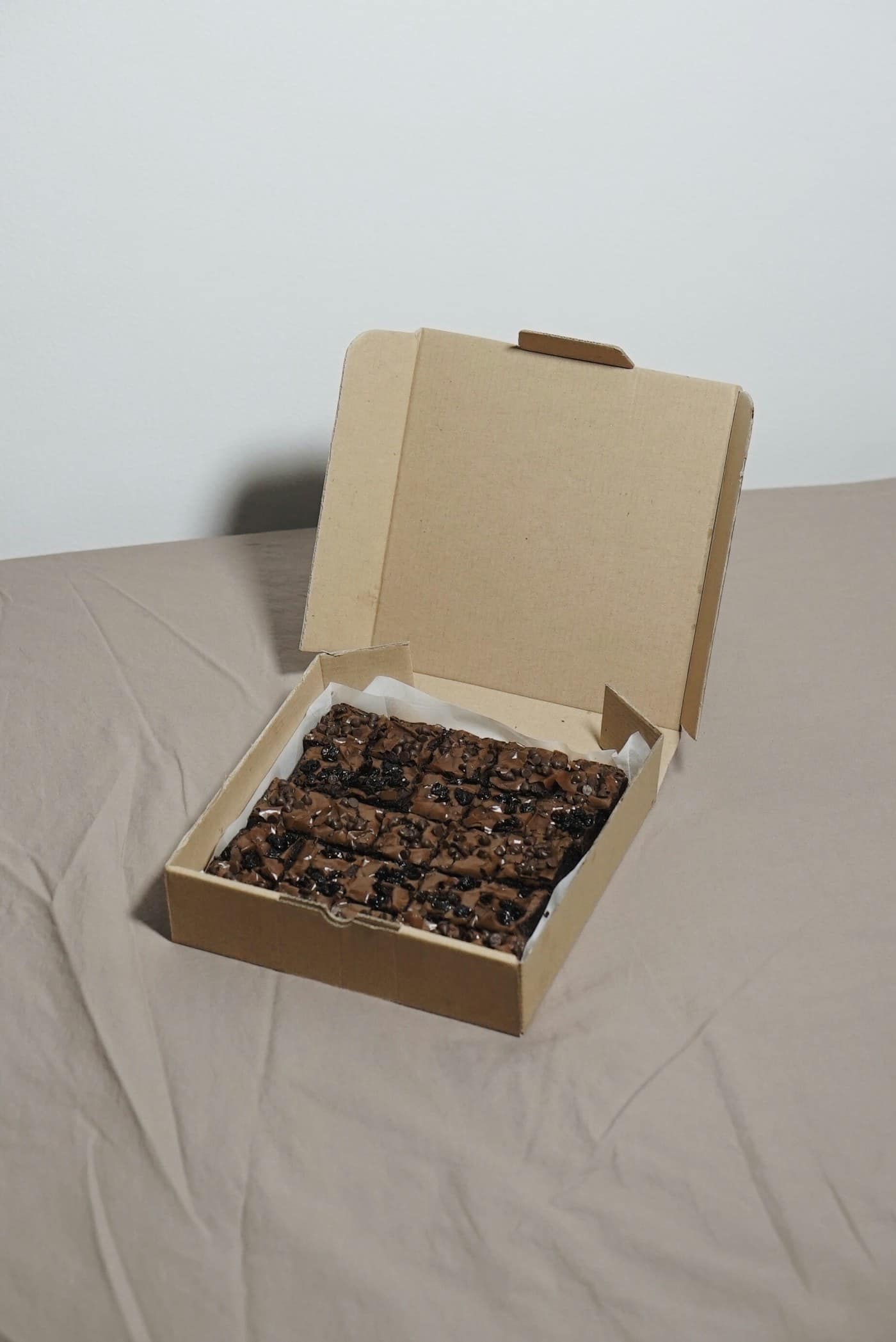 Squares of brownie packed into an open kraft box